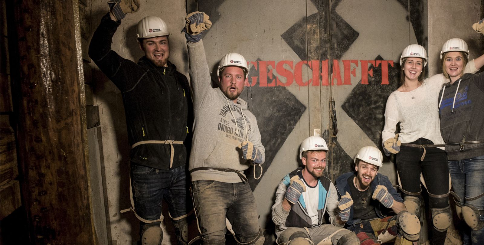 Eine Gruppe von Teilnehmern, die sich durch einen Schacht des Bergwerk Escape Room arbeiten.